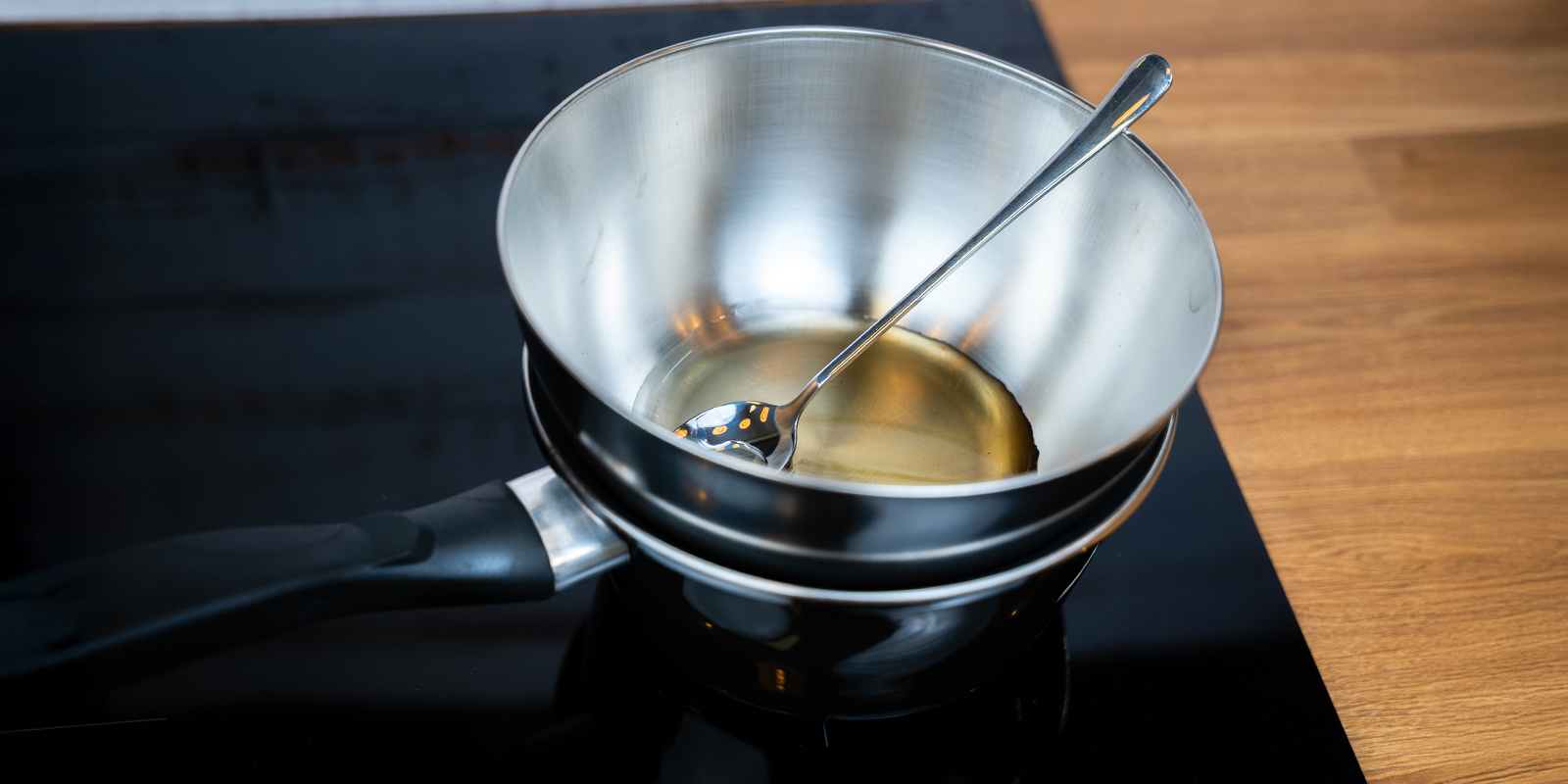 Place the bowl of cannabis honey on top of a saucepan